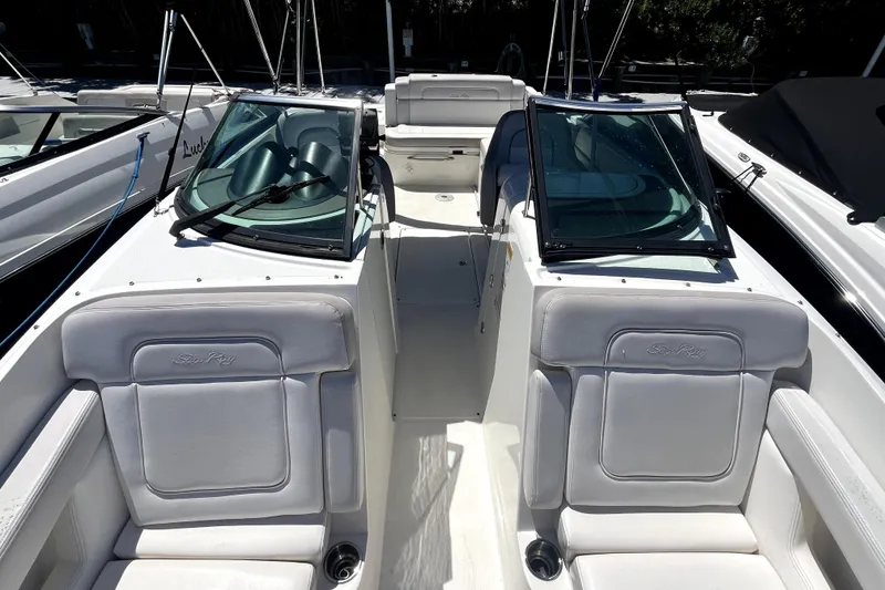 Slide: The Image of 2012 Sea Ray 260 Sundeck boat interior with white seating and storage compartment. - 13