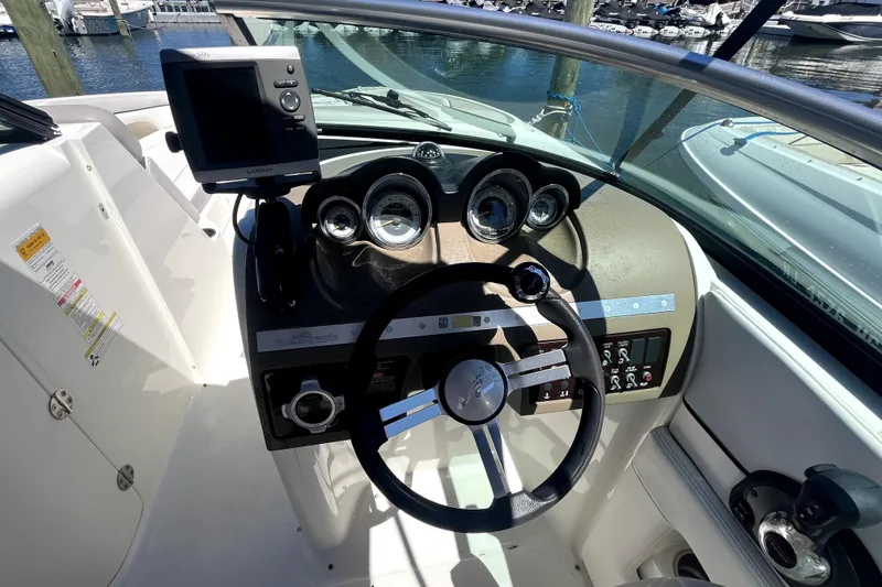 Slide: The Image of 2012 Sea Ray 260 Sundeck boat interior with open storage compartment. - 16