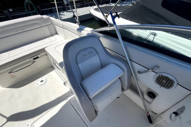 Slide: The Image of 2012 Sea Ray 260 Sundeck boat interior with white seating and dual windshields. - 17