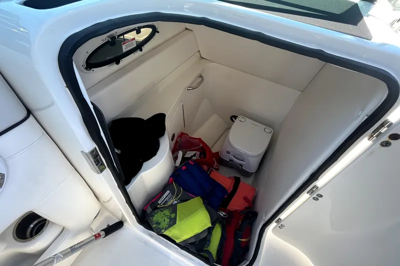 Slide: The Image of 2012 Sea Ray 260 Sundeck cockpit with steering wheel and captain's chair. - 19