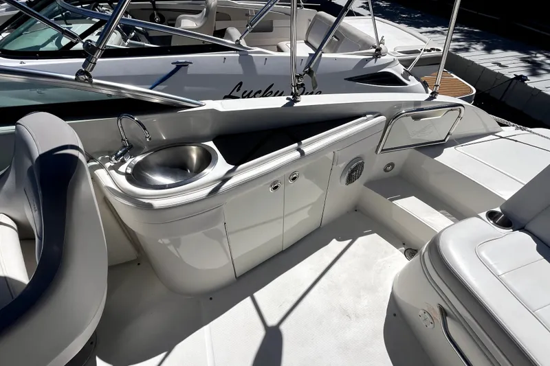 Slide: The Image of 2012 Sea Ray 260 Sundeck interior with white seating and stainless steel accents. - 21