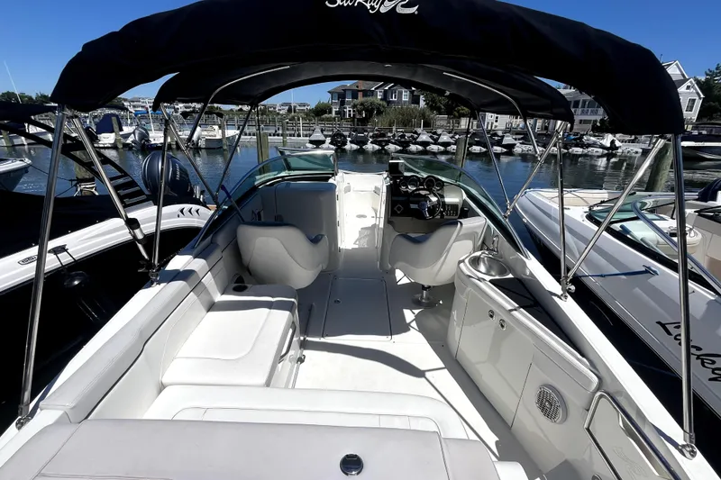 Slide: The Image of 2012 Sea Ray 260 Sundeck interior with white seating and spacious layout. - 24