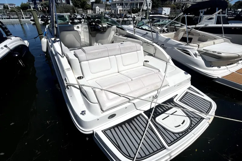 Slide: The Image of 2012 Sea Ray 260 Sundeck boat with canopy, docked in a marina. - 25