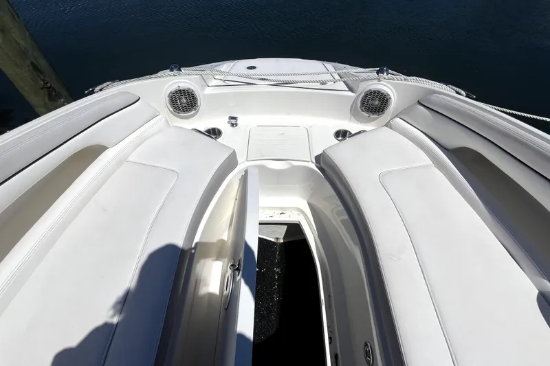 Slide: The Image of 2012 Sea Ray 260 Sundeck boat docked at marina, surrounded by other boats. - 9