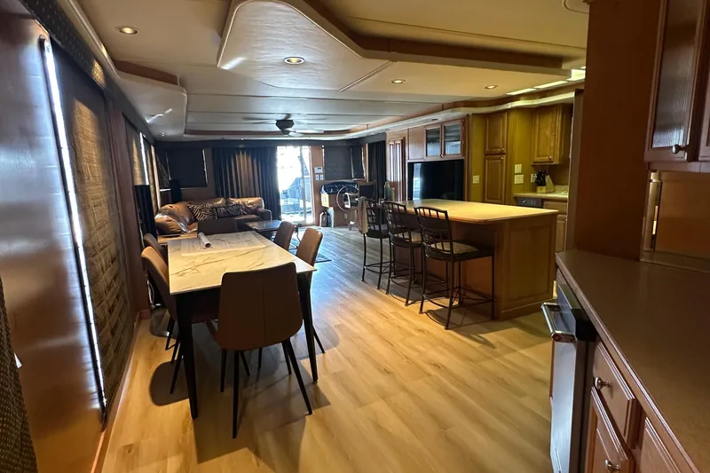 Slide: The Image of Luxurious interior of 2002 Sumerset 8516 houseboat with modern kitchen and dining area. - 2