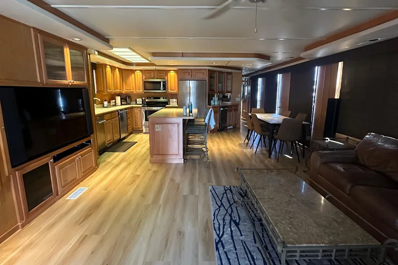 Slide: The Image of Luxurious 2002 Sumerset 8516 houseboat interior with modern kitchen and cozy living area. - 3