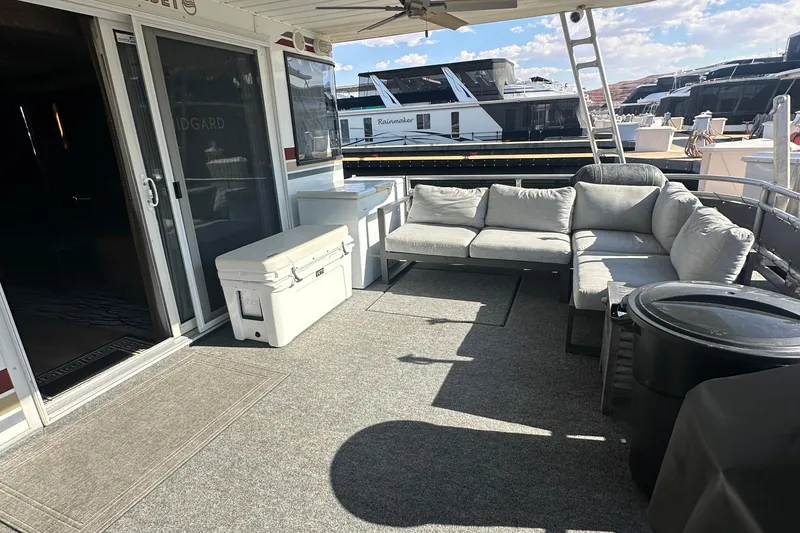 Slide: The Image of Outdoor seating area on a 2002 Sumerset 8516 houseboat with gray sofa and cooler. - 5