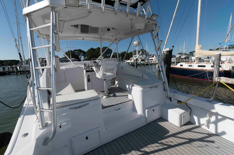Slide: The Image of 1998 Luhrs 32 Open boat interior with helm, seating, and marina view. - 12