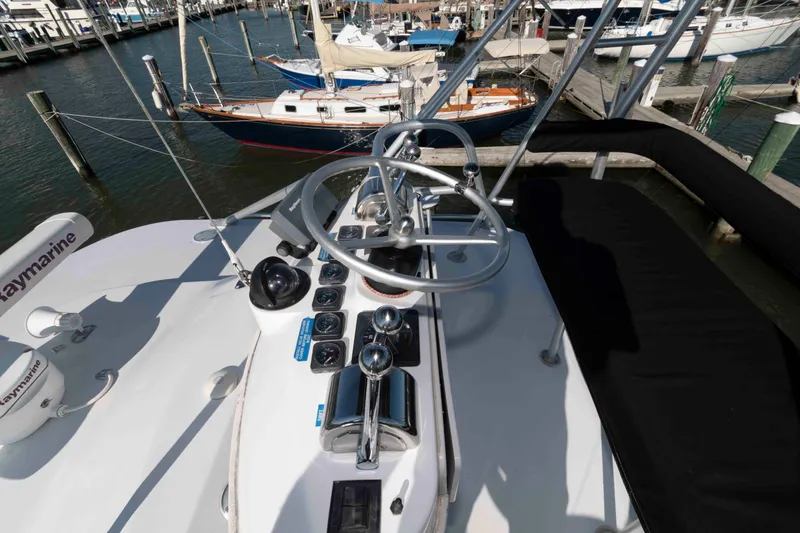 Slide: The Image of 1998 Luhrs 32 Open boat helm with steering wheel and controls at marina. - 16