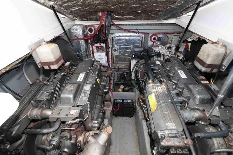 Slide: The Image of Engine room of a 1998 Luhrs 32 Open boat, showcasing dual engines and mechanical components. - 23