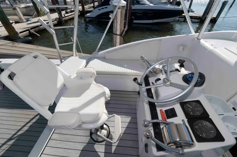 Slide: The Image of 1998 Luhrs 32 Open boat helm with steering wheel and controls at dock. - 6