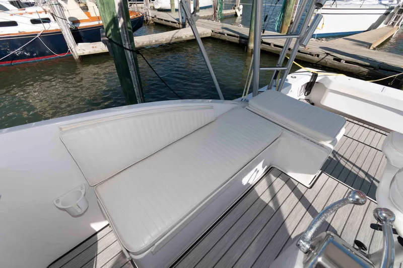 Slide: The Image of 1998 Luhrs 32 Open boat with white cushioned seating on deck, docked at marina. - 7