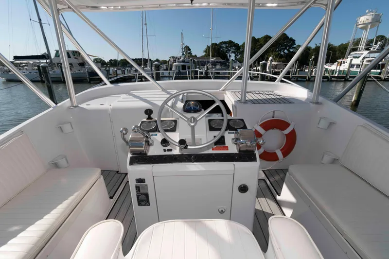 Slide: The Image of 1998 Luhrs 32 Open boat cockpit with steering wheel and marina view. - 8