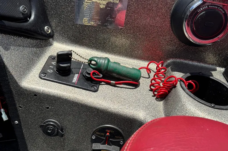 Slide: The Image of 1999 Skeeter ZX 195 boat dashboard with Yamaha controls and red coiled safety lanyard. - 10