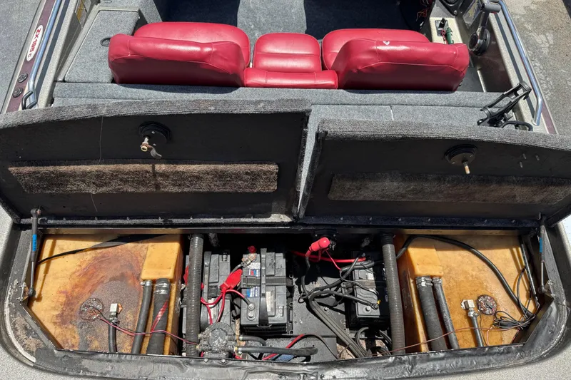Slide: The Image of 1999 Skeeter ZX 195 boat interior showing battery compartment and red seats. - 19