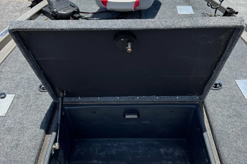 Slide: The Image of Open storage compartment on a 1999 Skeeter ZX 195 boat, featuring carpeted interior. - 22