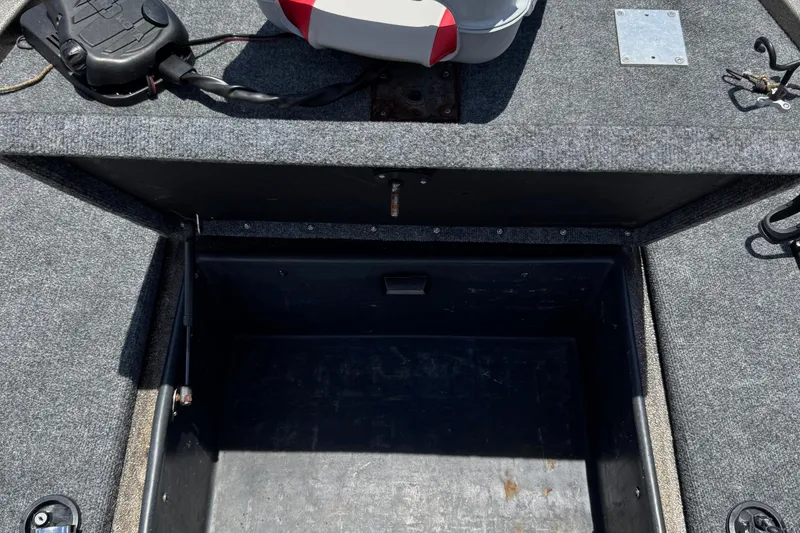 Slide: The Image of 1999 Skeeter ZX 195 boat storage compartment with open lid, showing interior space. - 23