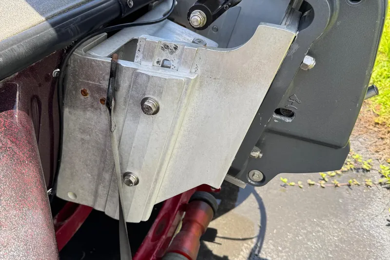 Slide: The Image of 1999 Skeeter ZX 195 boat engine mount with visible bolts and metal components. - 24