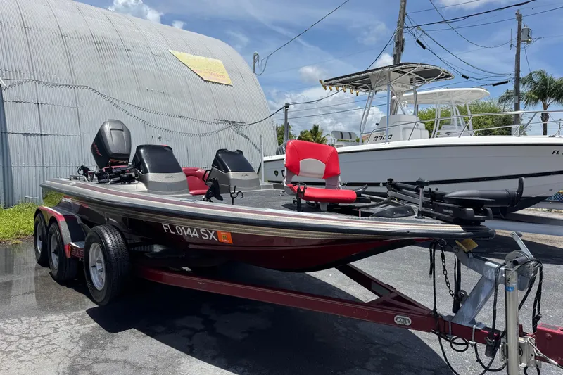 Slide: The Image of 1999 Skeeter ZX 195 boat on trailer, parked outdoors under a clear sky. - 3