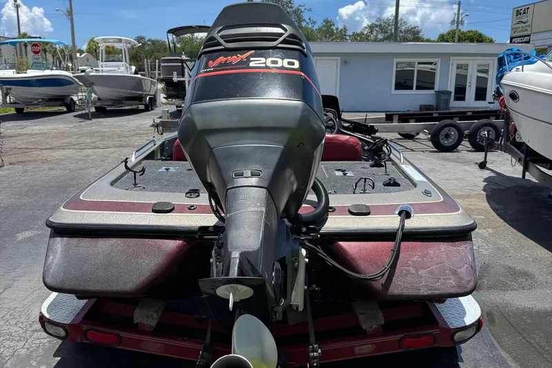 Slide: The Image of 1999 Skeeter ZX 195 boat with VMax 200 engine, parked outdoors. - 4