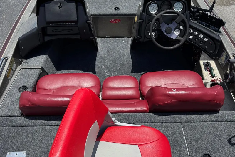 Slide: The Image of 1999 Skeeter ZX 195 boat interior with red seats and steering console. - 5