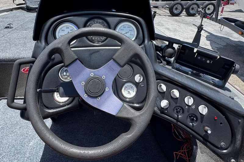 Slide: The Image of 1999 Skeeter ZX 195 boat dashboard with steering wheel and control gauges. - 7