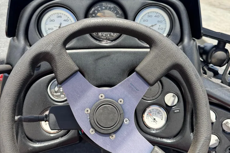 Slide: The Image of Steering wheel and dashboard of a 1999 Skeeter ZX 195 boat, featuring gauges and controls. - 8