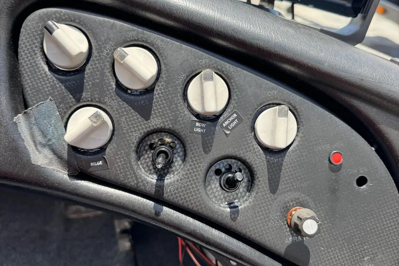 Slide: The Image of Control panel of a 1999 Skeeter ZX 195 boat with various switches and knobs. - 9