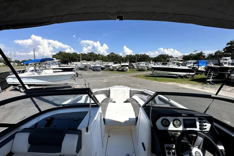 Slide: The Image of 2020 Yamaha Boats SX210 in a marina, surrounded by various other boats. - 15