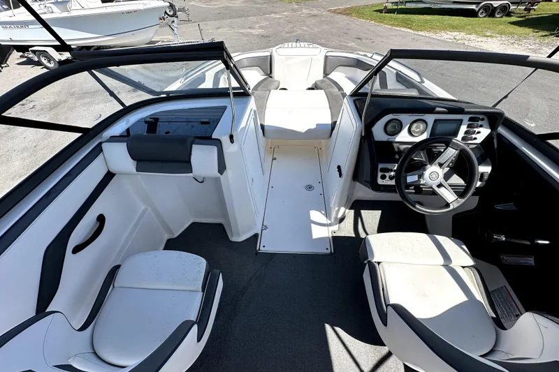 Slide: The Image of 2020 Yamaha Boats SX210 interior with steering wheel, seating, and dashboard controls. - 16