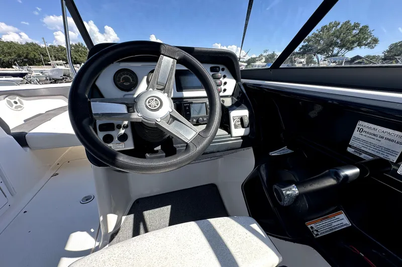Slide: The Image of 2020 Yamaha Boats SX210 cockpit with steering wheel and dashboard controls. - 17