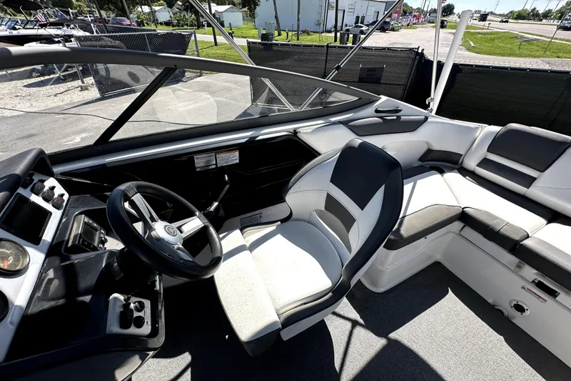 Slide: The Image of 2020 Yamaha Boats SX210 interior with steering wheel and seating area. - 18