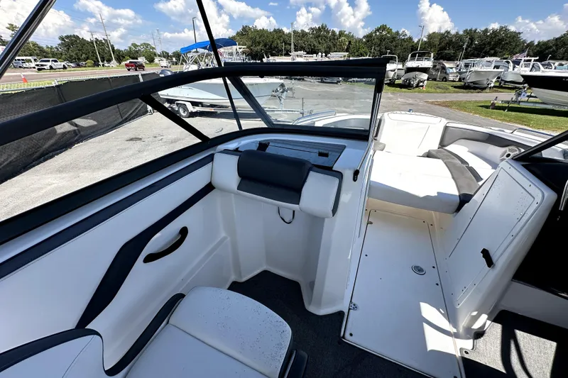 Slide: The Image of 2020 Yamaha Boats SX210 interior with seating, open deck, and clear skies in the background. - 19