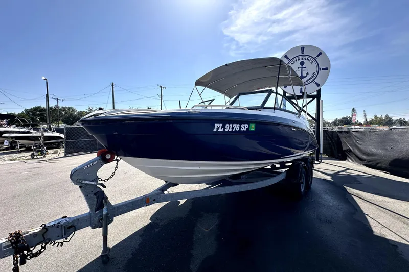 Slide: The Image of 2020 Yamaha Boats SX210 on trailer under clear blue sky. - 2