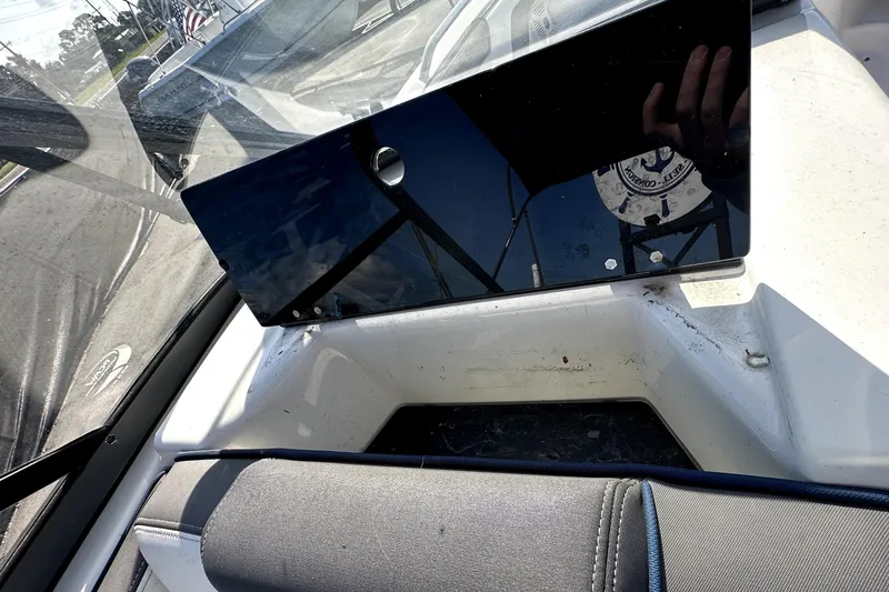Slide: The Image of 2020 Yamaha Boats SX210 dashboard with reflective panel and seating area. - 20