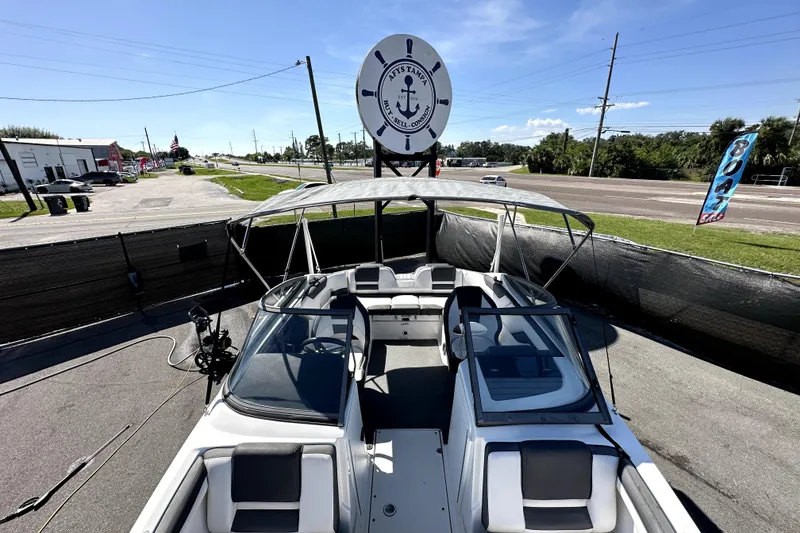 Slide: The Image of 2020 Yamaha Boats SX210 displayed outdoors with canopy and seating. - 25