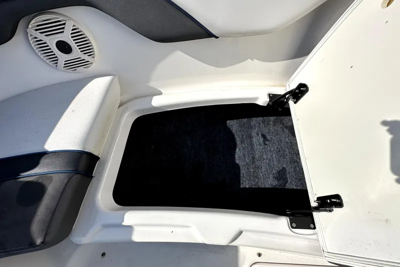 Slide: The Image of 2020 Yamaha SX210 boat interior storage compartment with speaker and seating. - 27