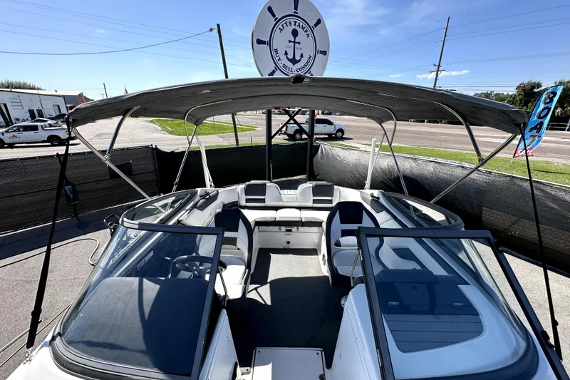 Slide: The Image of 2020 Yamaha Boats SX210 with canopy, parked outdoors under clear skies. - 29