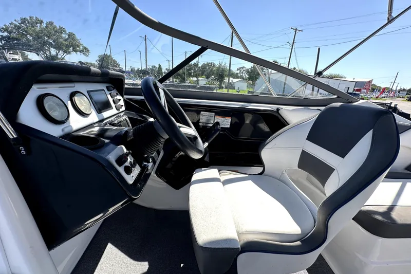 Slide: The Image of 2020 Yamaha Boats SX210 cockpit with steering wheel and dashboard controls. - 34