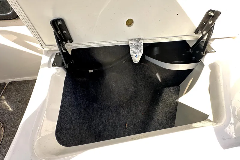 Slide: The Image of Open storage compartment in 2020 Yamaha SX210 boat, showing interior details. - 36