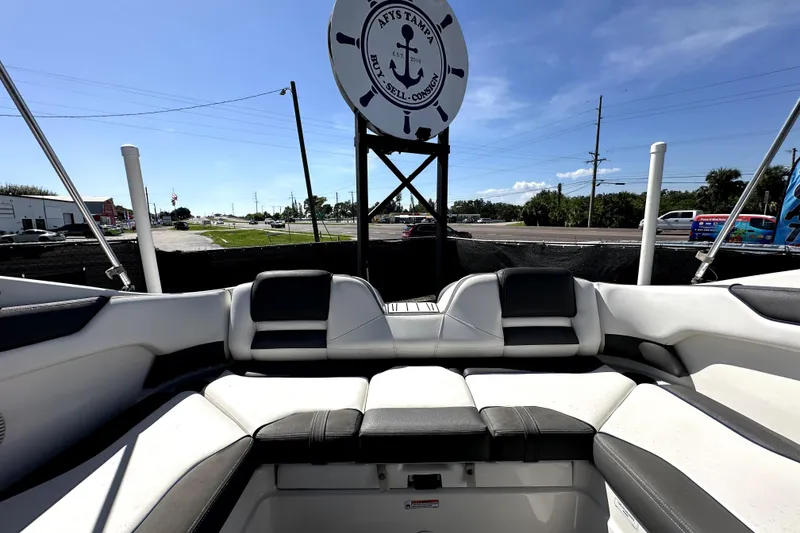 Slide: The Image of 2020 Yamaha Boats SX210 interior with seating, displayed outdoors under a clear blue sky. - 37
