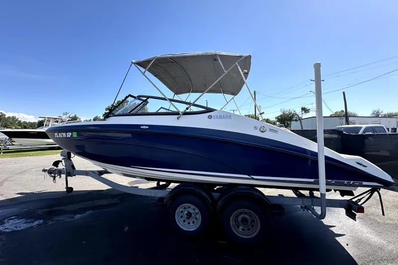 Slide: The Image of 2020 Yamaha SX210 boat on trailer under clear blue sky. - 4