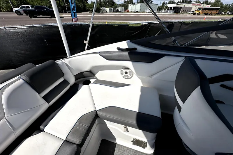Slide: The Image of 2020 Yamaha Boats SX210 interior with black and white seating, speaker, and windshield. - 42