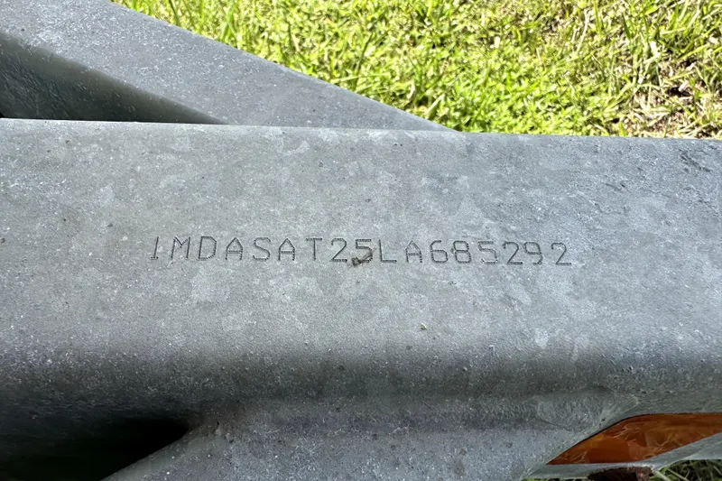 Slide: The Image of VIN on Yamaha Boats SX210 2020, engraved on metal surface, grassy background. - 46