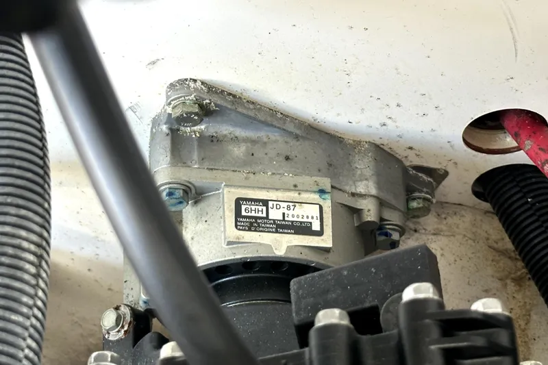 Slide: The Image of Close-up of a 2020 Yamaha SX210 boat engine component with visible label and wiring. - 48