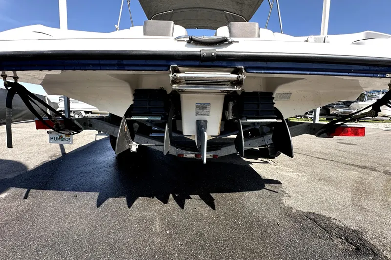 Slide: The Image of Rear view of 2020 Yamaha Boats SX210 on trailer, showcasing dual engines. - 7