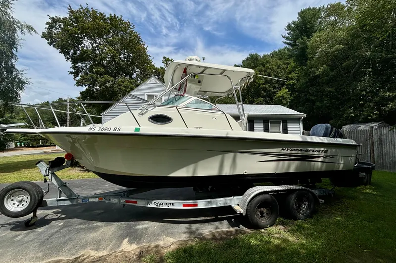 Slide: The Image of 2004 Hydra-Sports Lightning 230 WA boat on trailer, parked in a residential yard. - 3