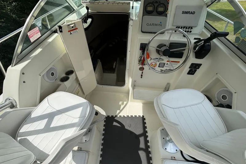 Slide: The Image of 2004 Hydra-Sports Lightning 230 WA boat interior with steering wheel and seating. - 4