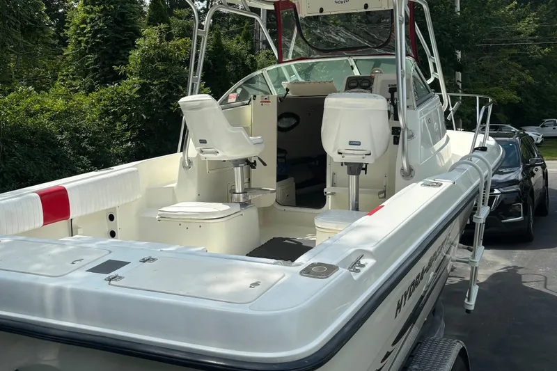 Slide: The Image of 2004 Hydra-Sports Lightning 230 WA boat with seating, parked outdoors. - 5