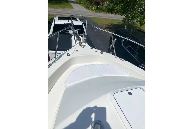 Slide: The Image of 2004 Hydra-Sports Lightning 230 WA boat deck with railing and seating area. - 6